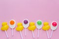 Bright yellow duck shaped candies and duck egg shaped candies on pink background. Royalty Free Stock Photo