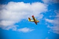 Bright Yellow Firefighter Plane in a Blue Sky
