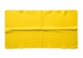 Bright yellow folded fabric laid out on a plain background Royalty Free Stock Photo