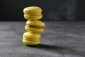 Bright yellow french macaroons on dark gray background. Horizontal format. Space for text Royalty Free Stock Photo