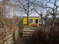 Bright yellow garden hut or small rustic home