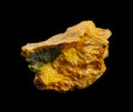 Bright yellow gold orpiment aka auripigmentum mineral from Middle Asia isolated on black background. Geology mineralogy