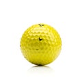 Bright yellow golf ball with black markings Royalty Free Stock Photo