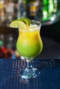 Bright yellow-green cocktail garnished with lime. Royalty Free Stock Photo