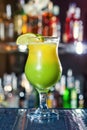 Bright yellow-green cocktail garnished with lime. Royalty Free Stock Photo