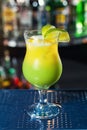 Bright yellow-green cocktail garnished with lime. Royalty Free Stock Photo