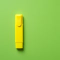 A bright yellow highlighter pen rests on a solid light green background. The pen has a Royalty Free Stock Photo