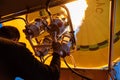 Bright yellow hot air balloon flying with gas fire flame heat equipment by pilot over Cappadocia, low angle view from inside