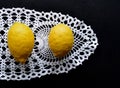 Bright Yellow Lemons, White Lace, Black Background Royalty Free Stock Photo