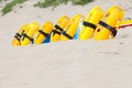 Bright yellow life saving equipment on the beach sand Royalty Free Stock Photo