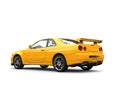 Bright yellow modern urban sports car - tail side view