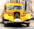 Bright yellow old vintage car in the main street in ErnÃÂ©e, Mayenne, France at the Foire st Gregoire 2018