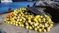 Bright yellow and orange fishing buoys and fish net piled at the fishing harbor, Port of Los Angeles, California. Royalty Free Stock Photo