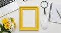 Bright Yellow Picture Frame Surrounded by Office and Floral Elements empty frame blank frame Royalty Free Stock Photo