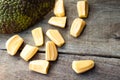 Bright yellow pieses of jackfruit on wooden background