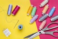 Scissors, set of sewing needles and bright colored threads on reels. Royalty Free Stock Photo