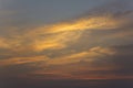 Bright yellow and pink clouds in a dark blue sunset sky Royalty Free Stock Photo