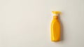 Bright yellow plastic bottle with a pump dispenser on a white background, suggesting a cleaning product or toiletry