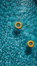 Bright yellow pool float and ring drifting in a crystal clear blue swimming pool Royalty Free Stock Photo