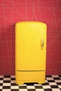 Bright yellow refrigerator in pink interior. Retro fridge looks awesome in modern interior. Stylish interior details Royalty Free Stock Photo