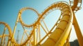 Bright yellow roller coaster loop under blue sky on a sunny day Royalty Free Stock Photo
