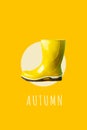Bright yellow rubber boot against the same color. A minimalist concept on the theme of autumn
