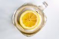 Bright yellow sliced lemon at the bottom of an empty glass mug with a handle. Lemonade ingredients for breakfast Royalty Free Stock Photo