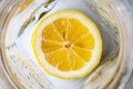 Bright yellow sliced lemon at the bottom of an empty glass mug. Lemonade ingredients for breakfast on a sunny morning Royalty Free Stock Photo