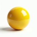 Bright yellow sphere rests on white surface. Simple round shape has subtle divide line. Object appears clean and isolated for Royalty Free Stock Photo