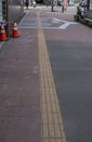 Bright yellow tactile footpath for people who have visually impaired on the walkway.