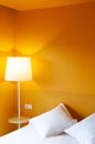 Bright Yellow wall bedroom decoration with lamp and clean linen