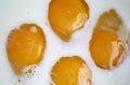 Bright yellow yolks in white milk. Spread the yolks on the white milk - making an omelet. Royalty Free Stock Photo