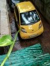 Bright Yelow TATA Nano car parked tight in small parking space in campound ghatkoper Mumba