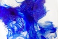 Brightl blue paint flows inside water with bubbles form of the butterfly Royalty Free Stock Photo