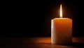 brightly burning candle in dimly lit room symbolizes hope and determination Royalty Free Stock Photo