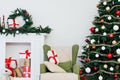 Brightly christmas tree with lots of gifts near window