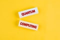 Exploring quantum computing concepts through bold block letters on a vibrant yellow background