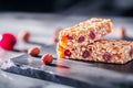 Brightly colored breakfast bar featuring a mix of nuts and dried fruits, placed on a dark surface, highlighting its Royalty Free Stock Photo