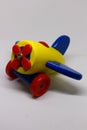 Brightly colored wooden toy plane isolated on a white background Royalty Free Stock Photo