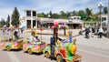 Brightly colored children`s train with young passengers to ride through the pedestrian streets of Kislovodsk