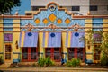 Brightly colored and decorated Mexican restaurant with awnings and modern office building in background Royalty Free Stock Photo