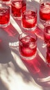 Brightly colored drinks arranged on a striped surface with reflections in sunlight Royalty Free Stock Photo