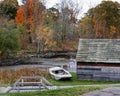 Abandoned wood boat sits in front of the iron warehouse at the Saugus Iron Works