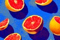 Brightly colored grapefruits arranged on a vibrant dotted background with striking shadows Royalty Free Stock Photo