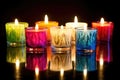 brightly colored homemade candles on a reflectively lit surface Royalty Free Stock Photo