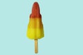 brightly colored ice lolly on a blue background Royalty Free Stock Photo