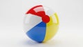 Brightly colored inflatable beach ball standing upright against a white background Royalty Free Stock Photo