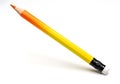 A brightly colored pencil with a gradient of orange and yellow hues rests on a white surface Royalty Free Stock Photo