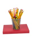 Brightly Colored Pencils Resting On a Red Book Royalty Free Stock Photo