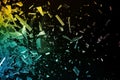 Brightly colored pieces of glass shattering against a black background, creating a vibrant and chaotic visual effect Royalty Free Stock Photo